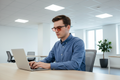 White man wearing black rectangle FL-41 glasses at office desk