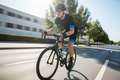 Person wearing FL-41 overfit glasses cycling on a bright sunny road