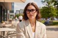 Person wearing Quamby 001 FL-41 overfit glasses outdoors